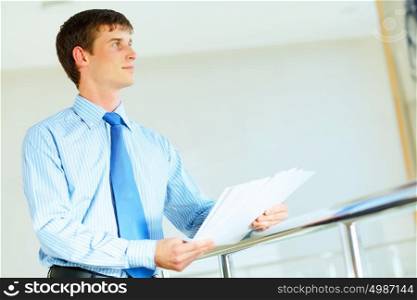 portrait of happy smiling young businesman. Portrait of happy smiling young businessman, standing in office
