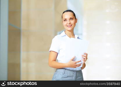 Portrait of happy smiling young businesswoman in office