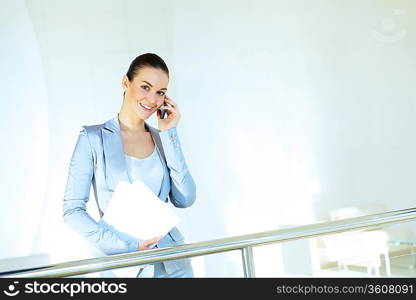 Portrait of happy smiling young businesswoman in office