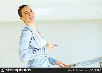 Portrait of happy smiling young businesswoman in office