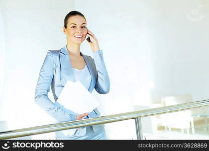 Portrait of happy smiling young businesswoman in office