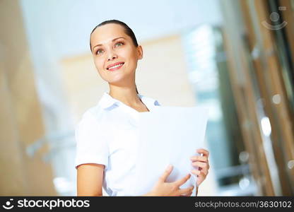 Portrait of happy smiling young businesswoman in office