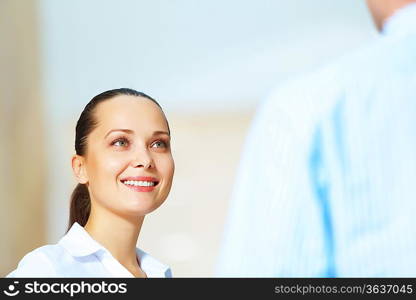 Portrait of happy smiling young businesswoman in office