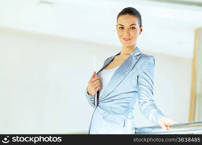 Portrait of happy smiling young businesswoman in office