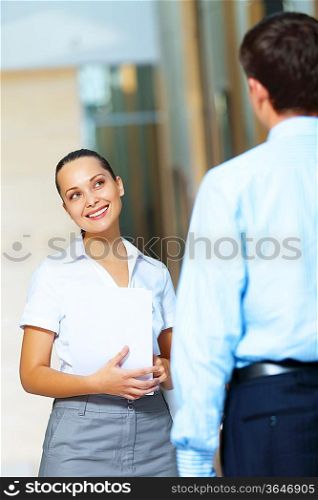Portrait of happy smiling young businesswoman in office
