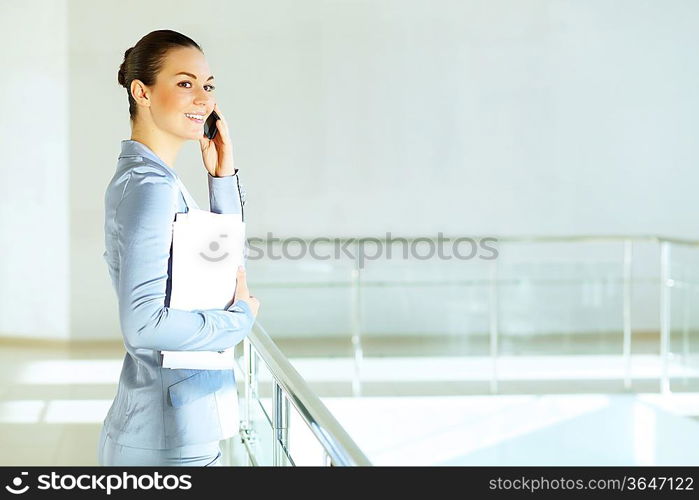 Portrait of happy smiling young businesswoman in office