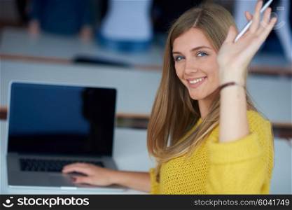 portrait of happy smilling student girl at tech classroom with laptop computer in background