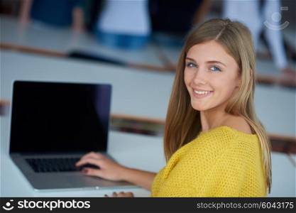 portrait of happy smilling student girl at tech classroom with laptop computer in background