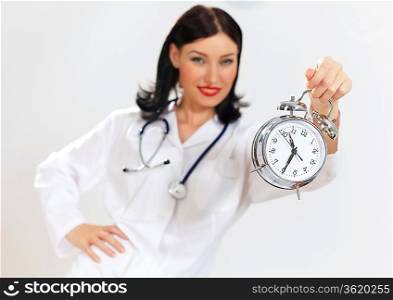 Portrait of happy successful young female doctor holding clocks
