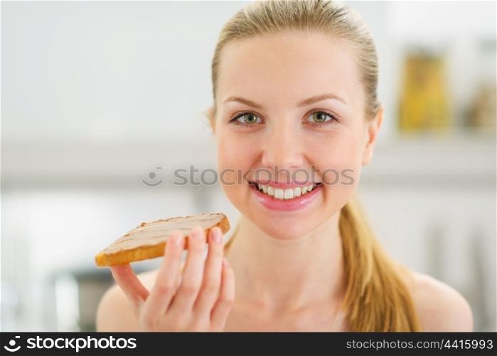 Portrait of happy teenage girl with toast with chocolate cream
