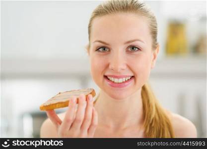 Portrait of happy teenage girl with toast with chocolate cream