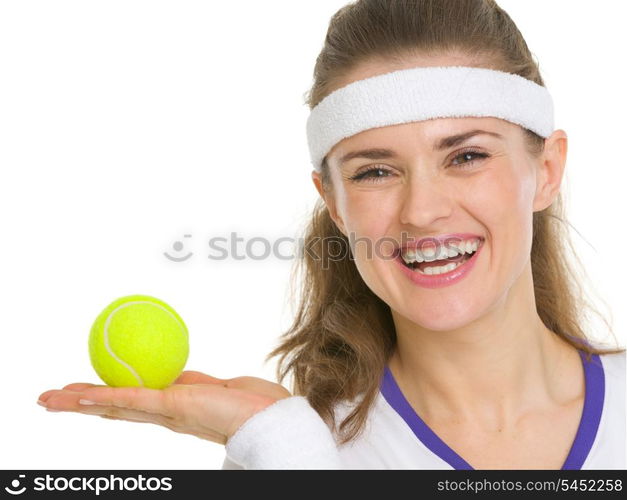 Portrait of happy tennis player showing tennis ball