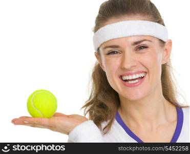 Portrait of happy tennis player showing tennis ball