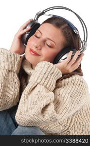 Portrait of happy woman enjoying music with headphones wearing turtleneck on white background