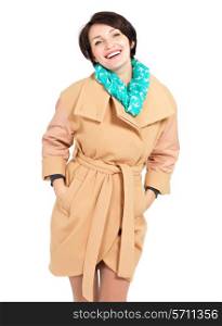 Portrait of happy woman in beige coat with green scarf standing isolated on white background