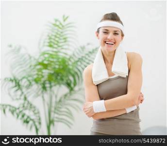 Portrait of happy woman in sportswear with towel