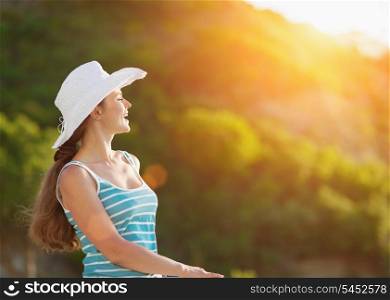 Portrait of happy woman on vacation enjoying sunset