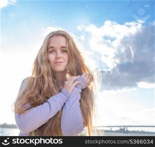 Portrait of happy woman smiling against clear sky