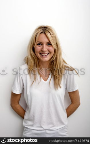 Portrait of happy woman standing against white background