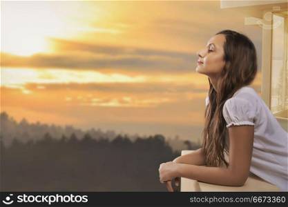 Portrait of happy woman standing at open window
