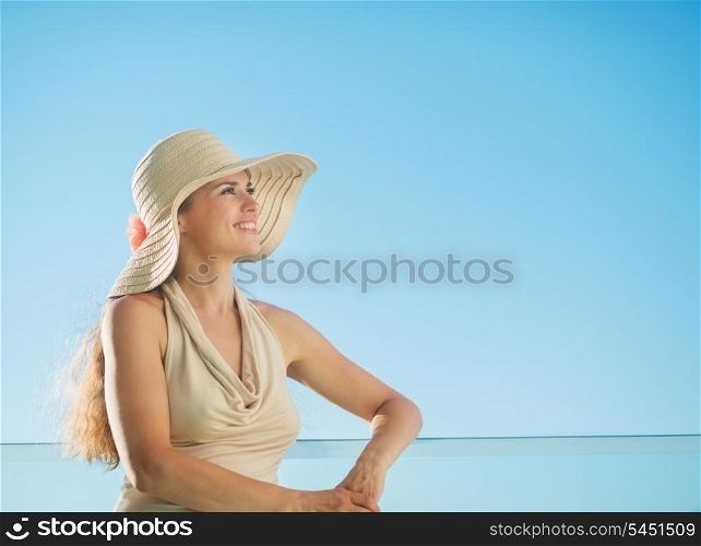 Portrait of happy woman standing on balcony
