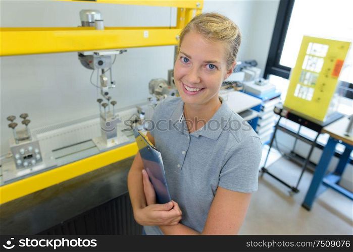 portrait of happy woman standing with clipboard
