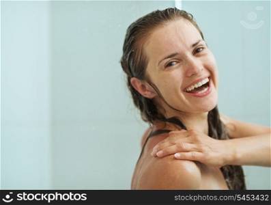 Portrait of happy woman taking shower