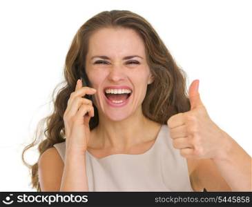 Portrait of happy woman talking mobile and showing thumbs up