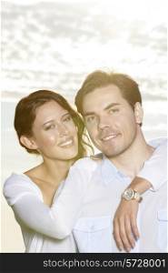Portrait of happy woman with arm around man at beach