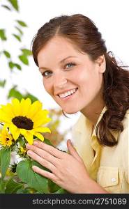 Portrait of happy woman with sunflower on white background