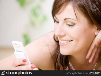 portrait of happy woman with white phone (focus on smile)