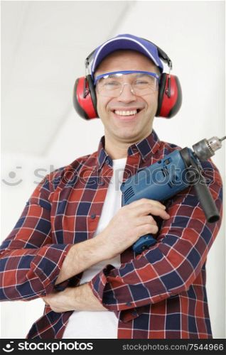 portrait of happy worker holding a drill
