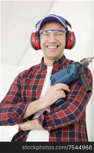 portrait of happy worker holding a drill