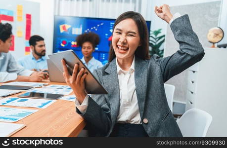 Portrait of happy young asian businesswoman with group of office worker on meeting with screen display business dashboard in background. Confident office lady at team meeting. Concord. Portrait of happy young asian businesswoman with in office meeting. Concord