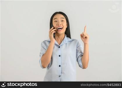 Portrait of Happy young asian woman expressing surprise while using mobile phone isolated over white background. Technology concept.