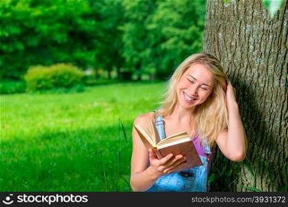 portrait of happy young blonde with a book