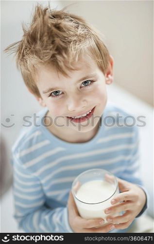 Portrait of happy young boy drinking milk