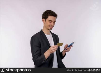 Portrait of happy young busi≠ssman standing using mobi≤cell pho≠and holding credit bank card isolated on white color background studio. Aχevement career wea<h concept.