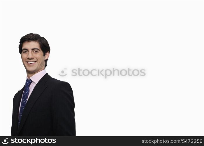 Portrait of happy young businessman against white background