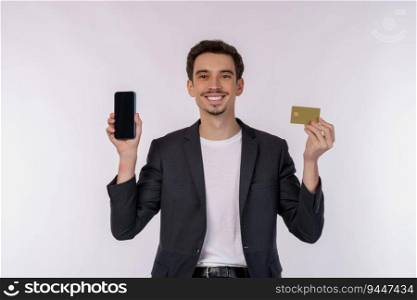 Portrait of happy young businessman standing showing mobile cell phone and holding credit bank card isolated on white color background studio. Achievement career wealth concept.