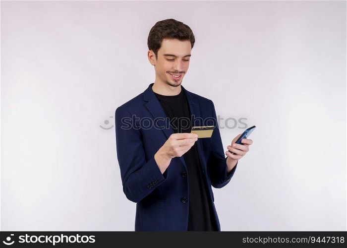 Portrait of happy young businessman standing using mobile cell phone and holding credit bank card isolated on white color background studio. Achievement career wealth concept.