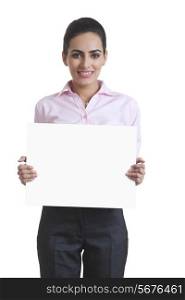Portrait of happy young businesswoman holding blank board over white background