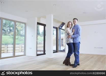 Portrait Of Happy Young Couple In New Home