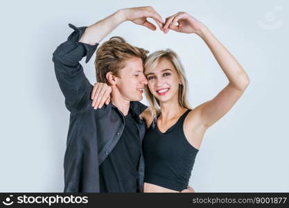 Portrait of happy young couple love together in studio