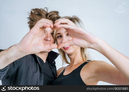 Portrait of happy young couple love together in studio