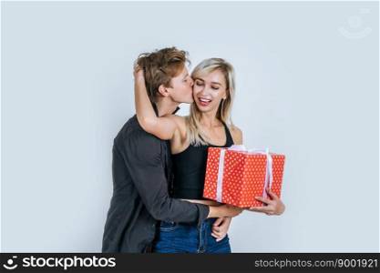 Portrait of happy young couple love together surprise with gift box in studio