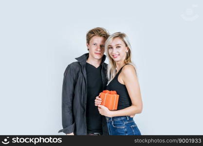 Portrait of happy young couple love together surprise with gift box in studio