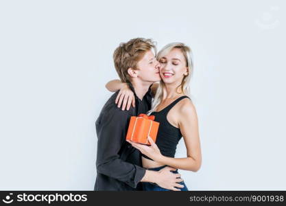 Portrait of happy young couple love together surprise with gift box in studio