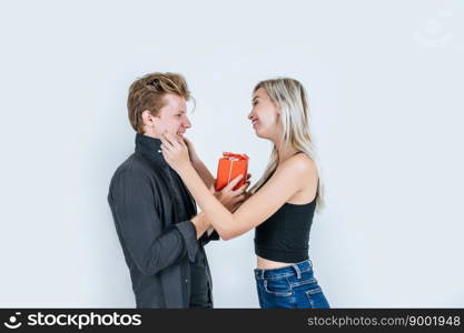 Portrait of happy young couple love together surprise with gift box in studio