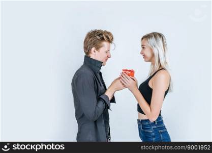 Portrait of happy young couple love together surprise with gift box in studio